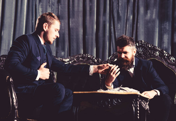 Two confident business men have business lunch at vintage restaurant - Фото, изображение