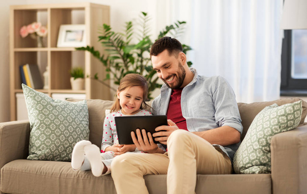 father and daughter with tablet computer at home - Φωτογραφία, εικόνα