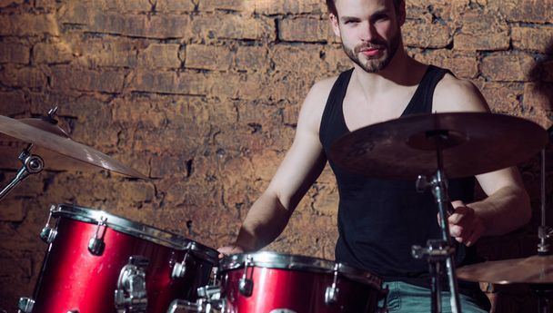 Heartbeat of the band. Man drummer playing musical instrument. Handsome man play percussion instrument. Rock concert or rehearsal in music club. Enjoying instrumental music. Rock star or rocker - Фото, изображение