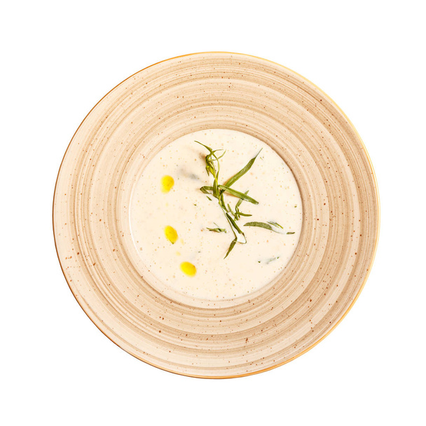 Flat lay of roasted potato cream soup with tarragon on white background - Foto, imagen