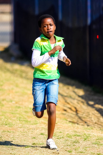 Pretoria, South Africa - August 26 2009: Diverse African Primary School children doing physical exercise PT lesson - Foto, Bild
