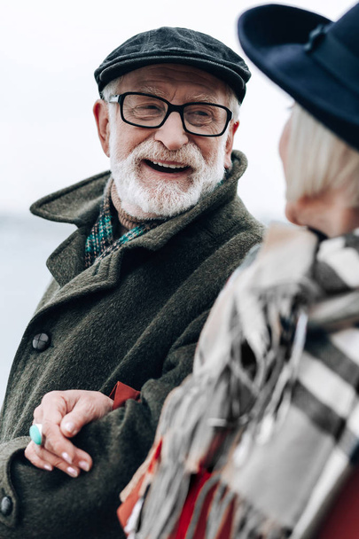 Cheerful bearded man spending time with pleasure - Fotografie, Obrázek