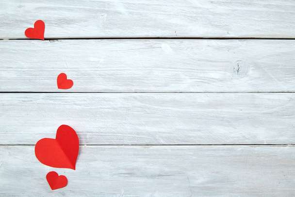 Coeurs en forme de papier rouge isolés sur fond de bois blanc, décorations pour la Saint-Valentin, Espace vide pour le design
 - Photo, image