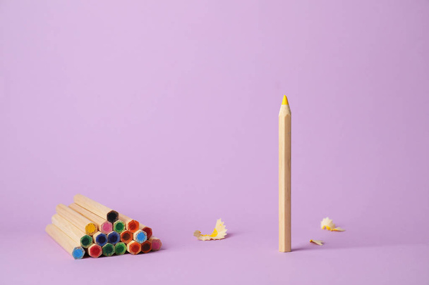 One pencil standing out from others on color background. Be different - Photo, image