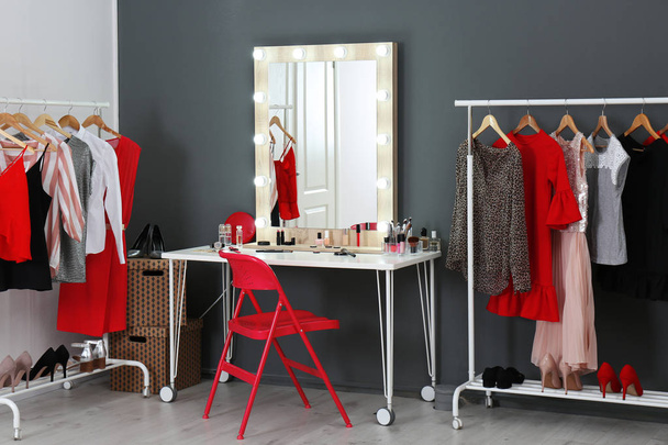 Stylish room with dressing table, mirror and wardrobe racks - 写真・画像