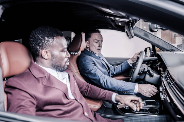 Two businessmen sitting in nice luxury car while going to meeting - Photo, Image