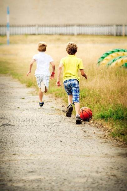 two boys playing soccer - Fotó, kép