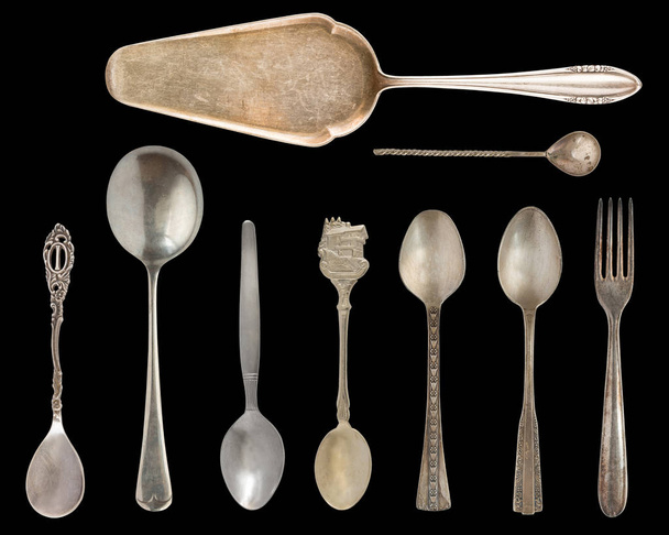 Vintage Silverware, antique spoons, knives, cake shovels isolated on isolated black background. Antique silverware. Retro. - Photo, Image
