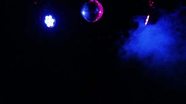 Mirror ball for disco in the rays of working lighting and smoke from the smoke machine. - Footage, Video
