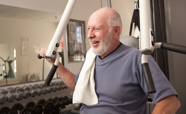 Старший взрослый мужчина тренируется в тренажерном зале
. - Фото, изображение