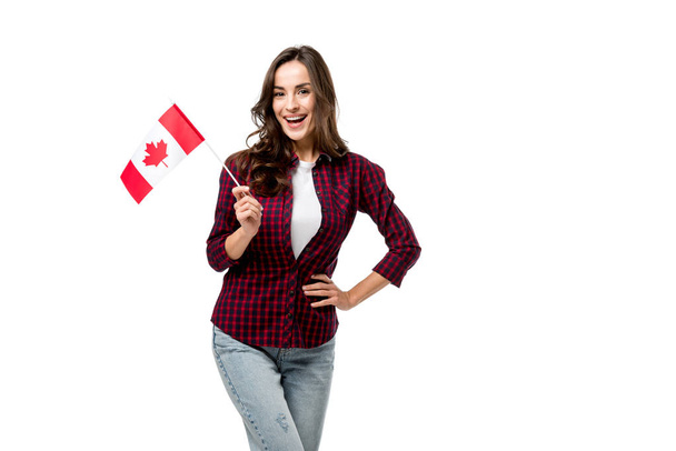 beautiful woman holding canadian flag and looking at camera isolated on white - Foto, immagini