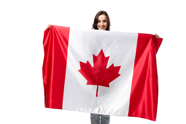 sonriente mujer sosteniendo bandera canadiense aislada en blanco
 - Foto, Imagen