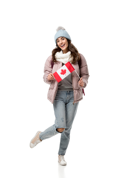 szczęśliwy kobiet student w zimowe ubrania trzymając flagi Kanady na białym tle - Zdjęcie, obraz