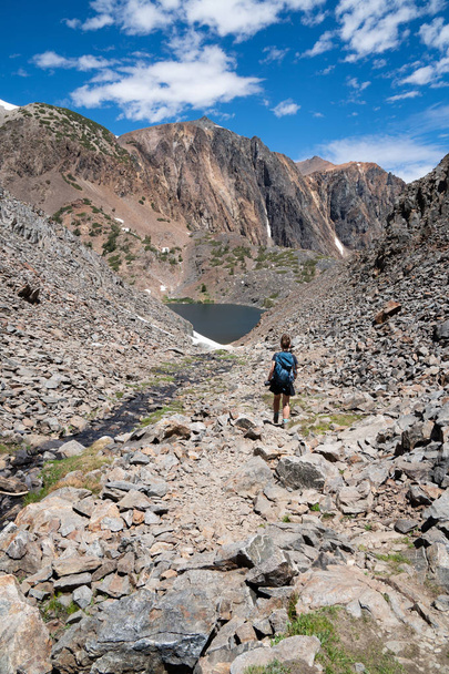 Une randonneuse descend un dangereux sentier de randonnée de éboulis et de talus dans les montagnes de l'est de la Sierra Nevada en Californie.
 - Photo, image