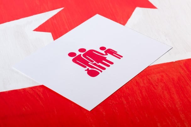 selective focus of white card with family icon on canadian flag, immigration concept - Photo, Image