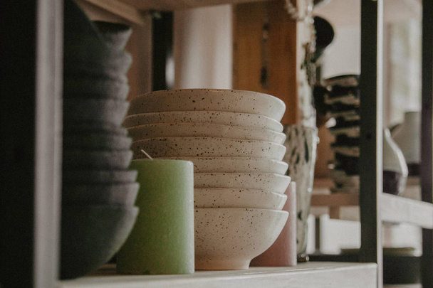 Stack of ceramic plates on cozy back - Fotografie, Obrázek