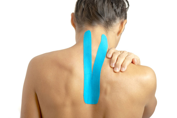 Female back with physio tape on white background - Foto, imagen