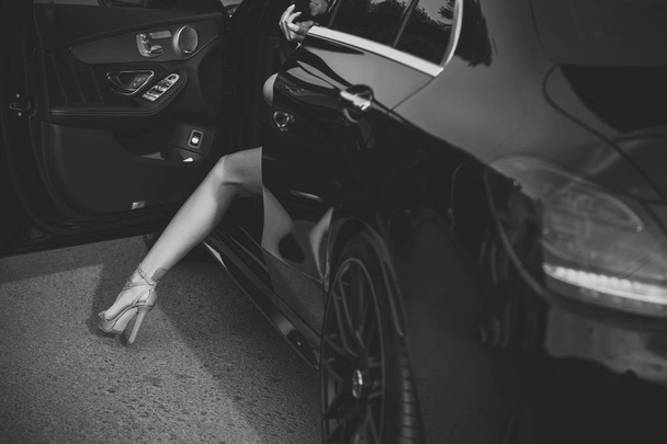 woman get out of car with sexy leg, business trip - Φωτογραφία, εικόνα