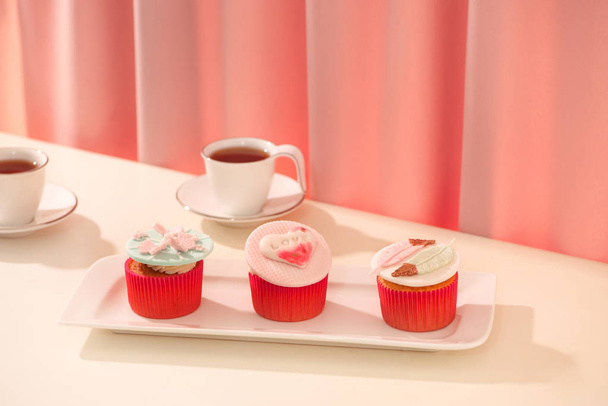 Valentine sweet love cupcakes on platter on light background - Photo, Image