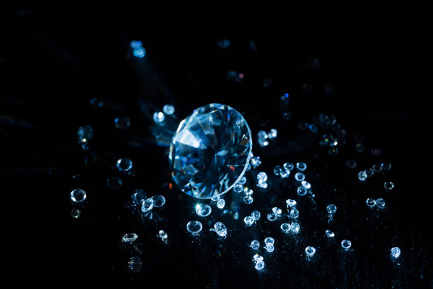 big and small transparent clear diamonds isolated on black - Foto, Bild