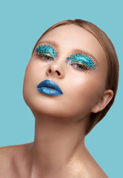 Beautiful woman's face with perfect art make up with glitter, beauty, cosmetics and makeup. Magic eyes look with bright creative make-up. - Zdjęcie, obraz