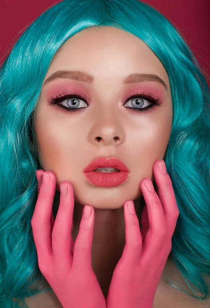 A beautiful girl with a bright pink makeup and a turquoise wig. Anime imag - Foto, imagen