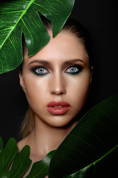 Studio beauty portrait of a beautiful girl  in tropical leave - Фото, изображение