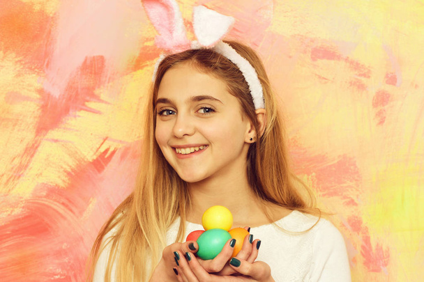 happy easter girl in bunny ears with colorful painted eggs - Photo, image
