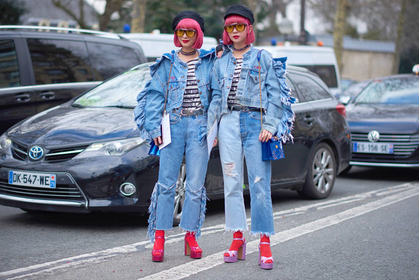 Trendy pedestrians walk on the street during the Paris Fashion Week Fall/Winter 2018 in Paris, France. - Zdjęcie, obraz