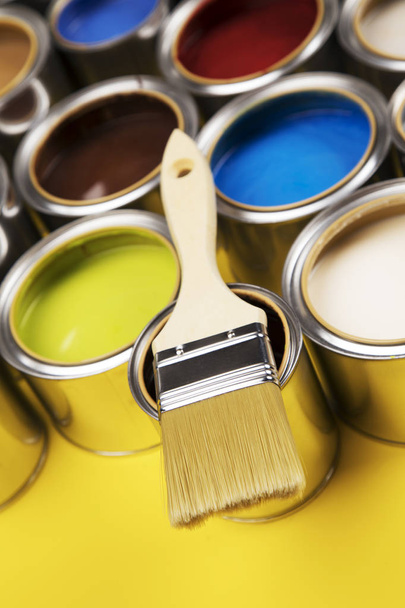 Can with paint and paintbrush, yellow background - Photo, Image