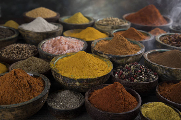 Variety of aromatic spices and herbs on kitchen table - Photo, Image