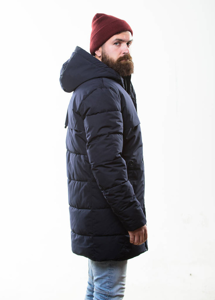Stylish and comfortable. Hipster modern fashion. Guy wear hat and black winter jacket. Hipster style menswear. Hipster outfit. Man bearded hipster posing confidently in warm black jacket or parka - Photo, Image