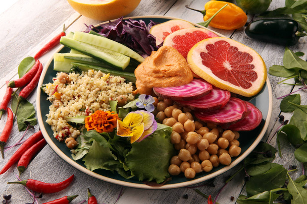 Bowl of Buddha, The concept of a healthy diet: chickpeas, salad, beetroot, pumpkin, cucumber, grapefruit, cabbage and tabouleh. Balanced food - Photo, Image