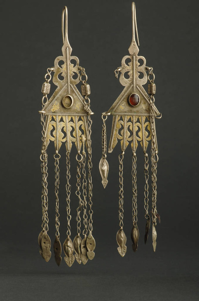 ancient antique earrings with stones on black background. Middle-Asian vintage jewelry - Photo, Image
