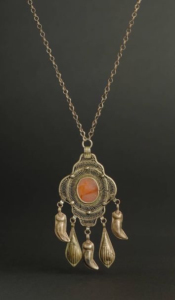 ancient antique pendant with stones on black background. Middle-Asian vintage jewelry - Photo, Image