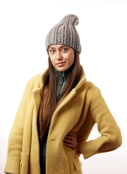 Fashionable hipster brunette woman model in stylish beige overcoat and gray hat - Photo, Image