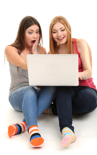 Two girl friends with with laptop isolated on white - Fotó, kép