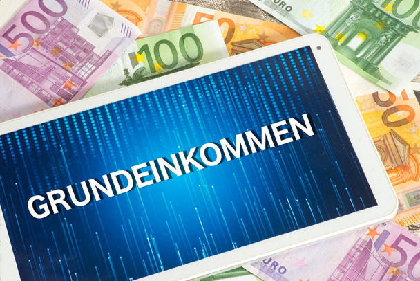 Euro banknotes, tablet pc and basic income - Photo, Image