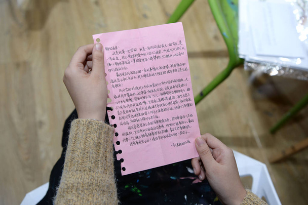 Chinese girl Qi Meng, one of the founders of a studio, reads a letter from people who want to relieve the stresses and anxiety through a miracle mailbox in Chengdu city, southwest China's Sichuan province, 8 December 2017 - Photo, Image