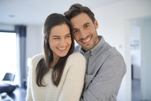  Portrait of gorgeous couple embracing at home                               - Фото, зображення