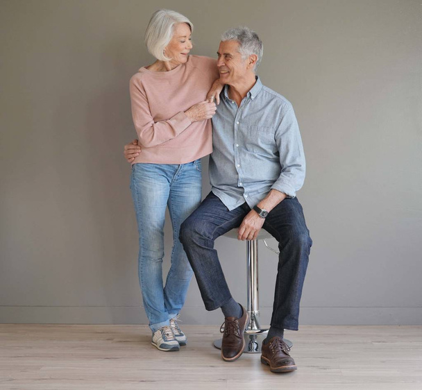  Full length of happy senior couple on grey background                               - Photo, image