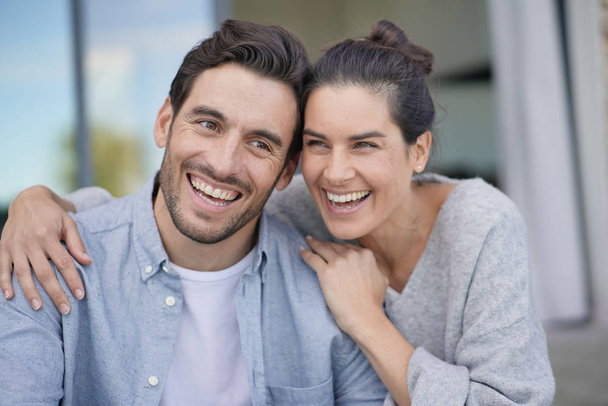  Portrait of very attractive couple smiling outside modern house                               - Fotoğraf, Görsel