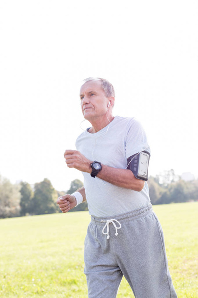 Active senior man running in park - Photo, Image