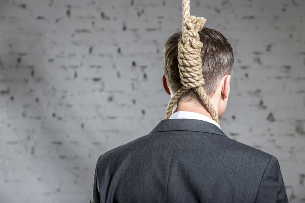 Rear view of businessman with noose at office - Photo, Image