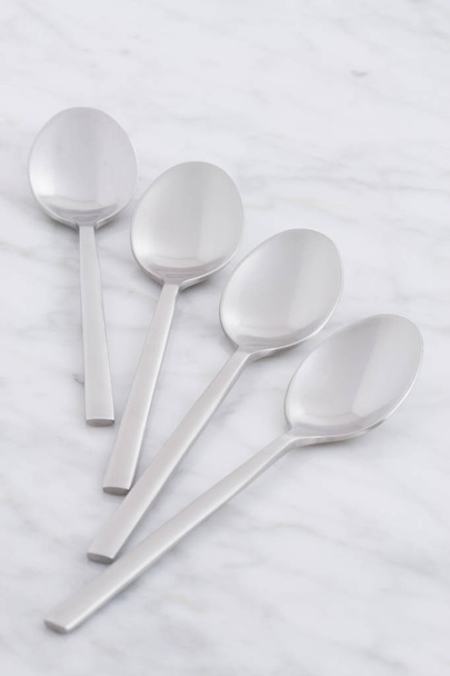 silver spoon set styled on antique carrara marble - Foto, Imagem