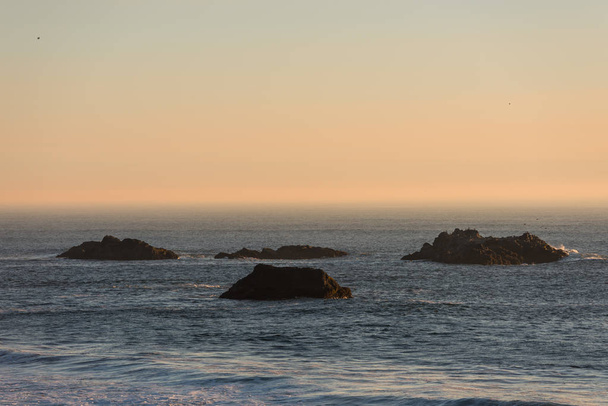 Islets protruding in the Pacific Ocean on a beach in Southern Oregon, USA - Photo, Image