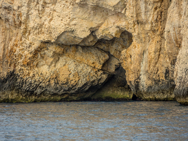 Blue cave entrance at island Vis in Croatia. Shot from sailing boat. - Photo, Image
