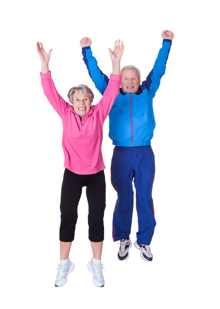 Portrait Of Senior Couple Jumping In Joy - Foto, imagen