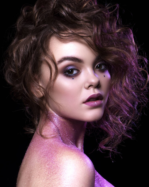 Close up of a gorgeous sexy woman with creative fashion make up: glitters and glamour shine. Curly evening hairstyle. Sexy look. - Zdjęcie, obraz