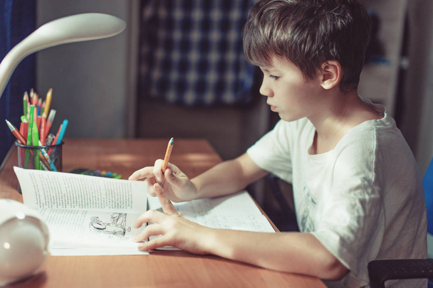Young little kid doing homework or learning at home - Fotografie, Obrázek